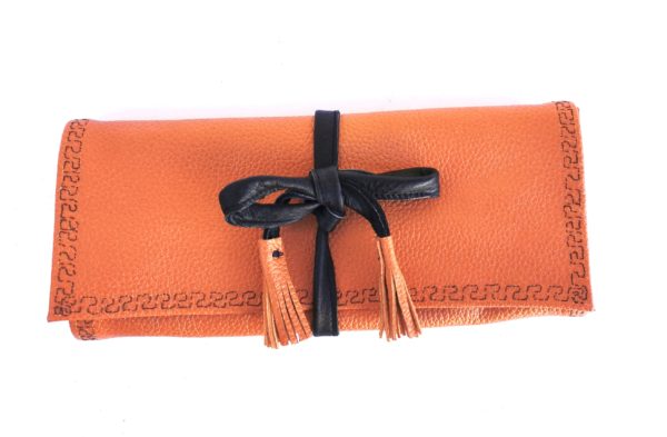 trousse à bijoux cuir orange, intérieur blanc imprimé de valises